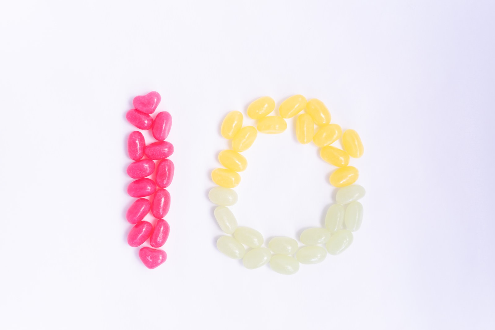 Number 10 made with pink candy and yellow and white jelly beans