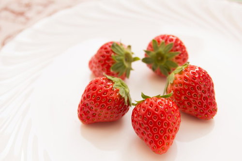 白い丸皿に円を描くように並んだいちご