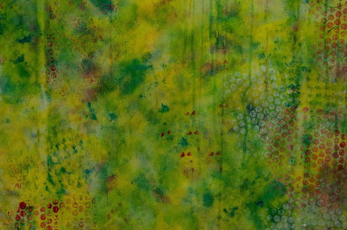 黄色と緑の絵の具で描かれた円形模様の抽象画テクスチャー