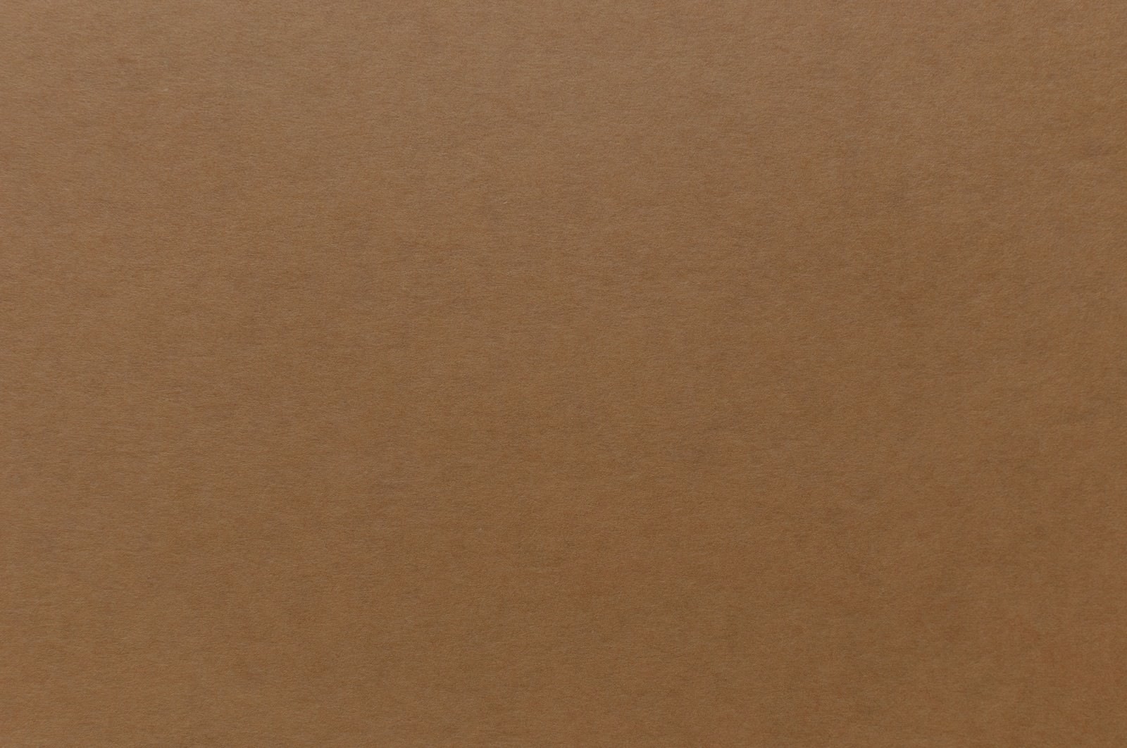 茶色い厚紙の表面をアップで撮影したテクスチャー写真