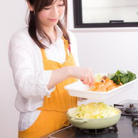 鍋パーティの用意をしている料理研究家の妻の写真