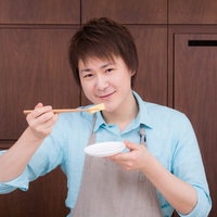 生徒が作った玉子焼きの味を確認する料理研究家の写真