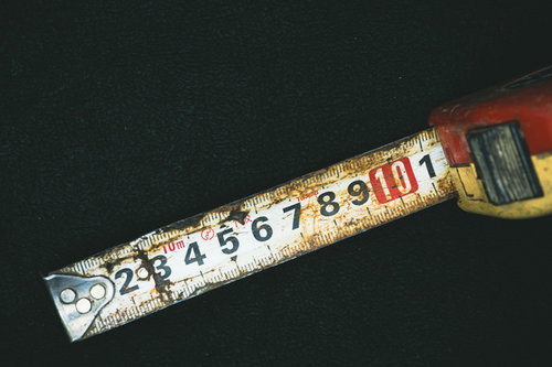 錆びて変色した古いメジャーと目盛り・金属製の測定工具