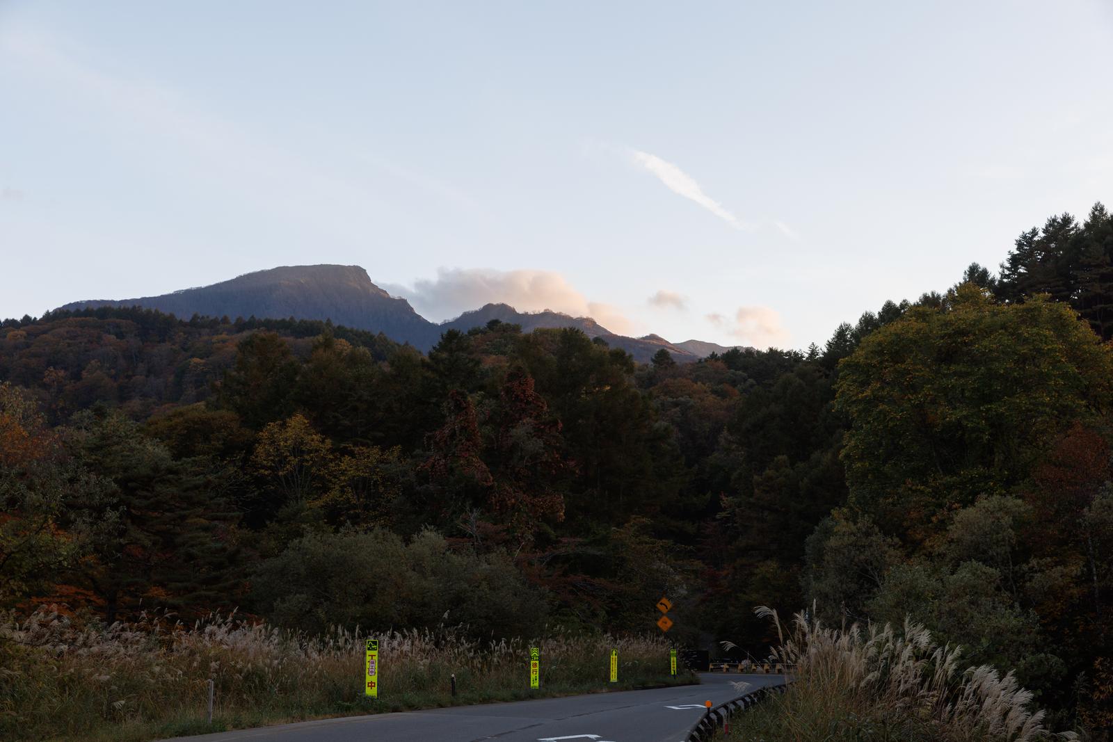 磐梯山を背景に黄色い標識が立つ猪苗代町の林道入口