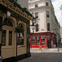 看板と建物が並ぶロンドンの商店街のストリートの写真