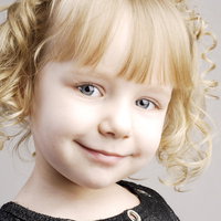 にっこり笑顔のブロンドの女の子、金色の巻き毛の写真