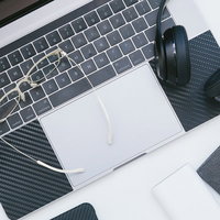 ノートパソコンの上に眼鏡とヘッドフォンを置いて一休みの写真