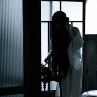 通販で買った白装束のサイズが合わないのでお客様相談室に電話する女性の写真