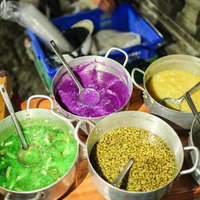 川沿いに立ち並ぶ大型看板とゴミが散乱するホーチミンの空き地の写真