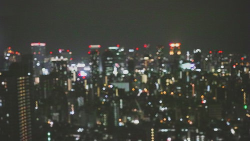 ピンボケした都会の夜景、ビル群の光と色彩