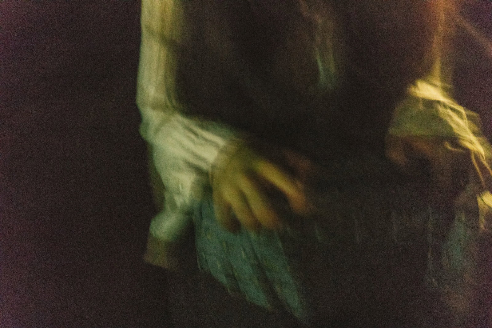 暗闇の中で動く女性の手を写した不気味な雰囲気の写真