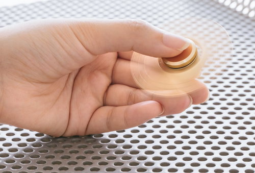 金色のハンドスピナーが手のひらでシュルシュル回る