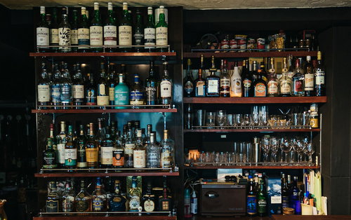 バーの酒棚に並ぶウイスキーとスピリッツボトル