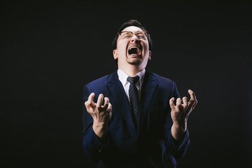 愕然として叫び狂うドイツ人ハーフの男性がスーツ姿で咆哮