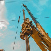 大型クレーンが青空の下で稼働している様子の写真