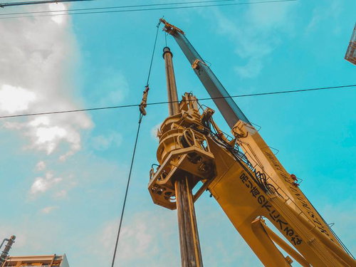 大型クレーンが青空の下で稼働している様子