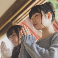 仲良くお参りをする女性たちの祈願、寺院での参拝風景の写真