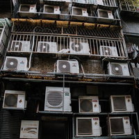 台湾の雑居ビル裏に密集するエアコン室外機の群像の写真