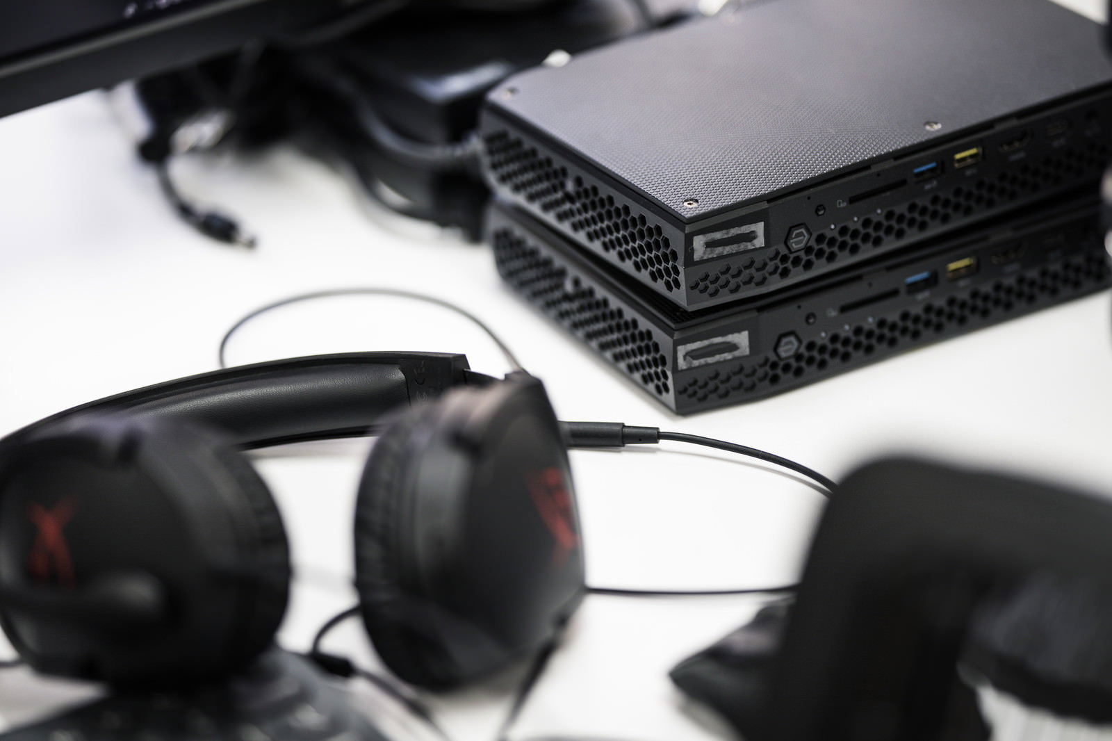 白いデスクの上に置かれた黒いNUC小型PCとサングラス