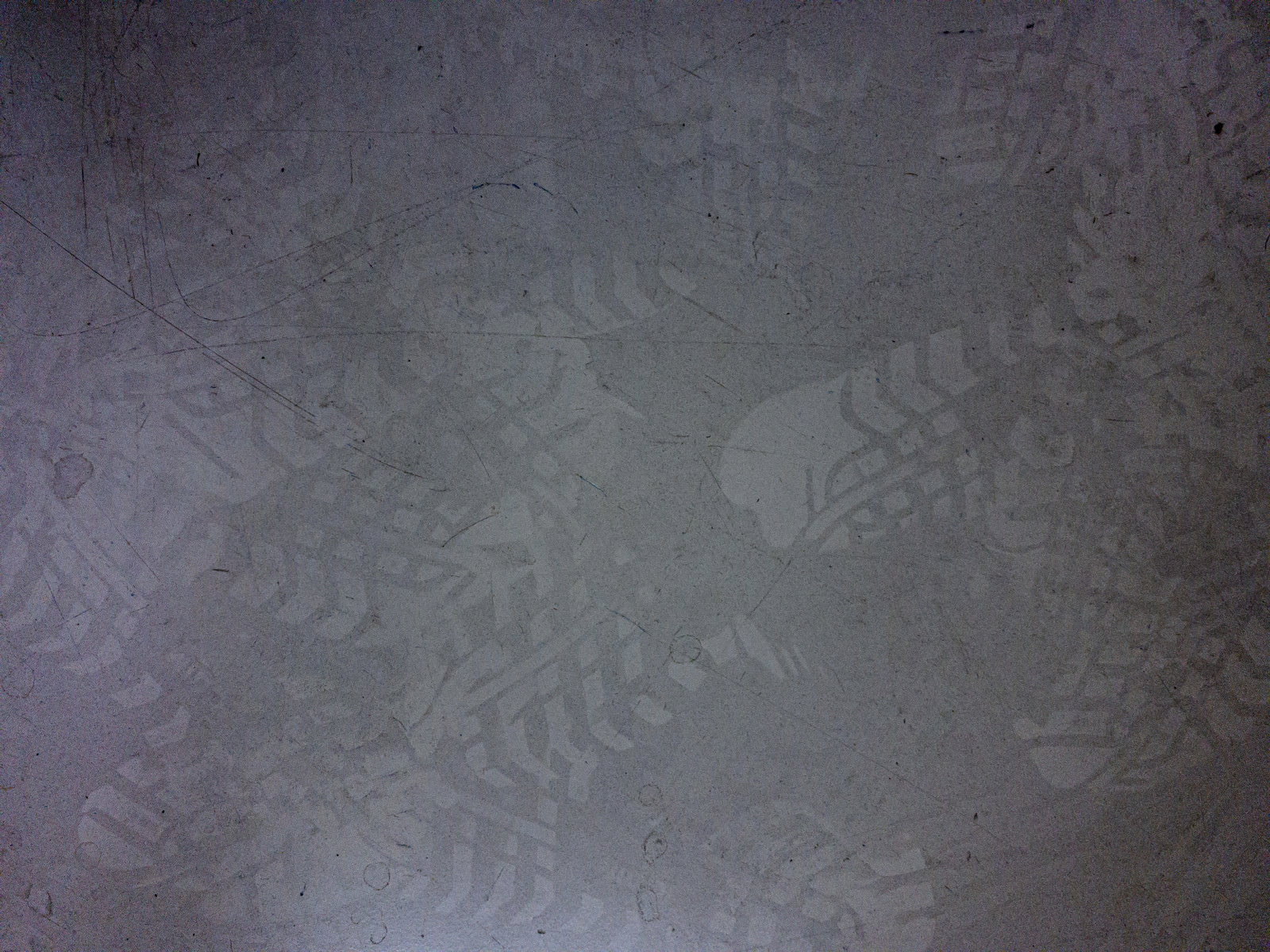 Numerous footprints overlapping on a gray floor