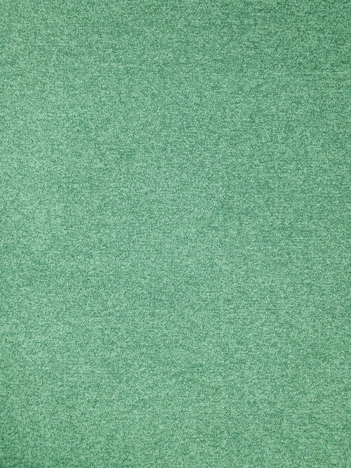 グリーンのタイルカーペット、均一に敷き詰められたテクスチャー