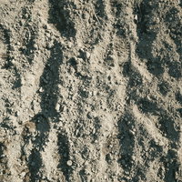 耕した畑の土と足跡のテクスチャーの写真