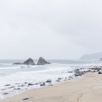 福岡県糸島の二見ヶ浦にある夫婦岩と鳥居が立つ砂浜の写真