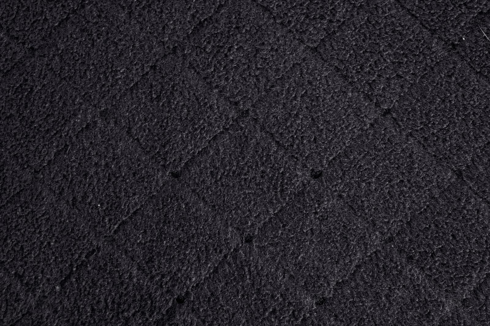 黒い粗い質感の吹付けタイルのテクスチャー表面