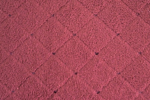 赤いダイヤモンド柄の絨毯のテクスチャ