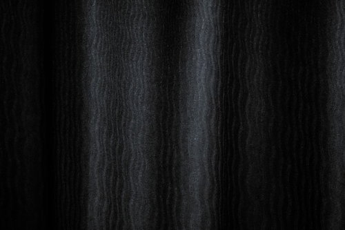 薄暗い波模様の布テクスチャー