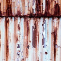 赤茶色に錆びたトタン板の波状加工テクスチャーの写真