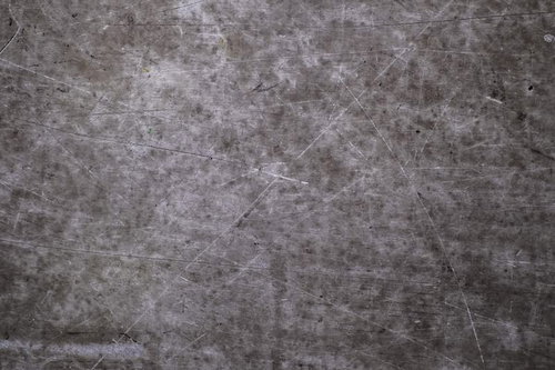 傷つけられたグレーのコンクリート壁テクスチャー