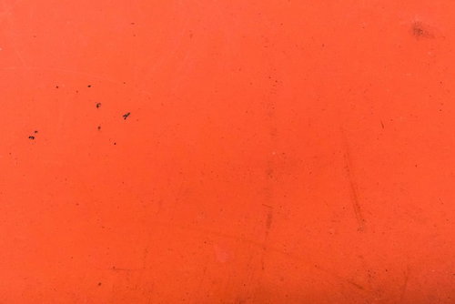 少しだけ錆びた赤い壁のテクスチャ