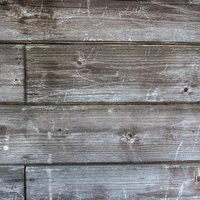 傷が残る木造の壁板のテクスチャの写真