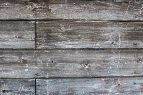 傷が残る木造の壁板のテクスチャ