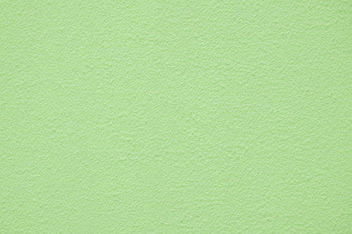 淡い緑色に塗装された外壁のテクスチャと塗装質感