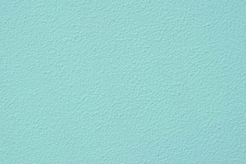 淡いミントカラーに塗られた外壁のテクスチャー