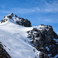 残雪から突き出す岩石の岩峰、中央アルプスの宝剣岳の写真