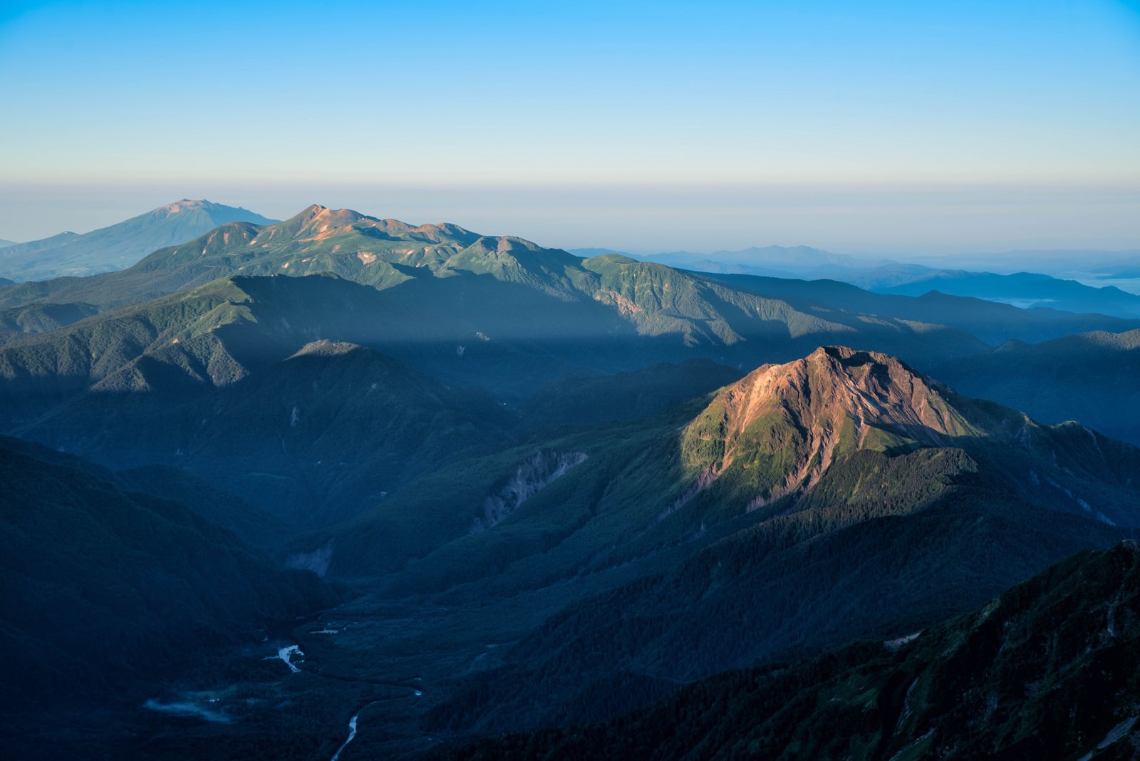 朝焼けに照らされる焼岳と乗鞍岳の遠景