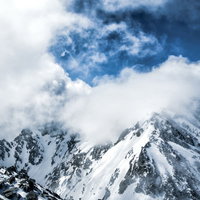 湧き上がる雲と雪化粧の穂高連峰の写真
