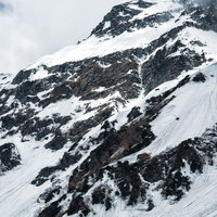 奥穂高岳の雪に覆われた断崖と岩壁（飛騨山脈北アルプス）の写真