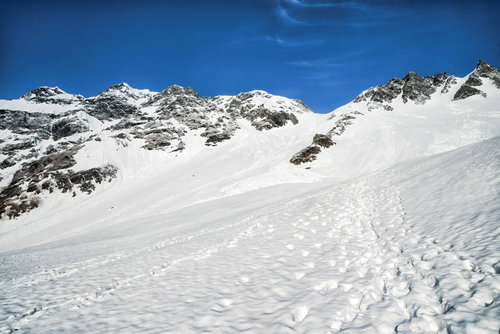 残雪期の奥穂高岳とザイテングラード、登山者の足跡が続く岩尾根