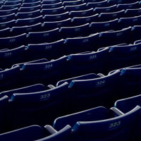 等間隔に整然と並ぶスタジアムのベンチの写真