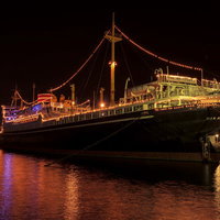 夜の港でライトアップされた氷川丸の写真