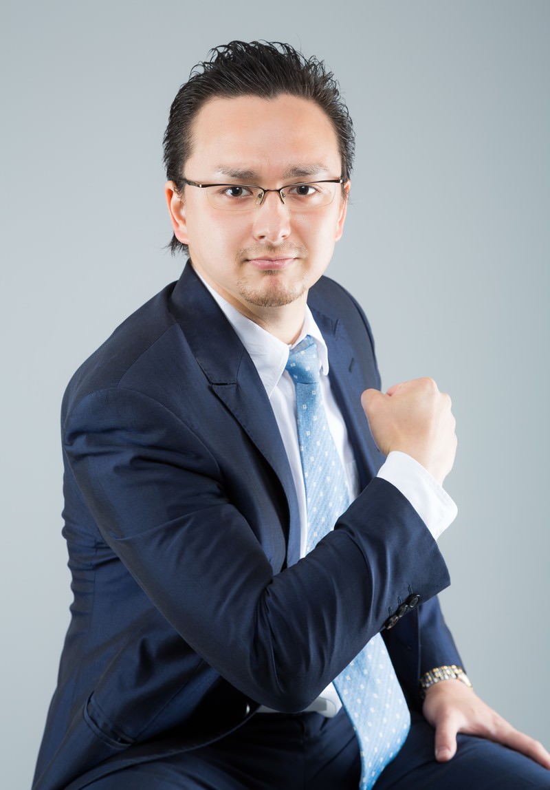 グーを握るスーツ姿のハーフ男性［モデル：Max_Ezaki］