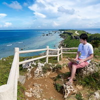 東平安名崎を一望しながらノマド中の男性の写真