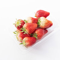 白い容器に入った未熟なとちおとめいちごの新鮮フルーツの写真