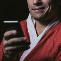 スマホでサンタコスイベント情報を検索する男性の写真