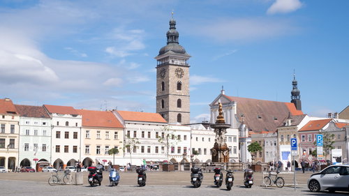 チェスケーブジェヨヴィツェの広場に駐車するバイクと時計塔