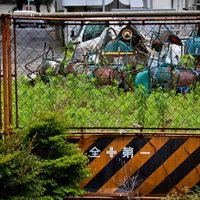 錆びた資材と瓦礫が散らばる荒れ果てた資材置き場の写真